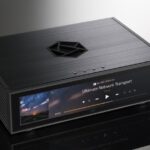 HiFi Rose RS130 Uncompromised Audio Purity With a focus on delivering pristine sound, the RS130 is engineered to eliminate digital noise and ensure stable output. Its support for Fiber Optic Ethernet and Fiber Optic USB effectively blocks unwanted noise sources, allowing you to indulge in pure audio bliss. The built-in high-precision OCXO clock guarantees precise timing, maintaining a constant temperature for stable and accurate clock signals. Sophisticated Aesthetics and Engineered for Perfection Designed to captivate audiophiles both audibly and visually, the RS130 boasts exquisite crystal buttons that exude class and elegance. Complemented by a novel symbol logo-inspired ventilation hole, the RS130 ensures efficient heat dissipation while adding a touch of sophistication to your space. Pure Power, Pure Sound For the cleanest and most stable power supply, the RS130 employs a linear power stage powered by a high-capacity supercapacitor. This innovative approach reduces power supply noise to near battery levels, resulting in cleaner and more natural sound quality. Unleashing Precision Experience unrivaled precision with the high-precision OCXO. This cutting-edge clock source delivers an accurate and stable clock signal unaffected by temperature changes. Say goodbye to jitter in the audio signal, and embrace a more stable and precise audio performance. Unrivaled Noise Suppression The RS130 leverages Fiber Optic Ethernet to completely isolate network digital noise. It effectively blocks physical noise sources, including various network equipment. Similarly, the Fiber Optic USB employs optical conversion to separate pure data from driving noise, ensuring only flawless sound reaches your DAC. Seamless Synchronization Embrace perfect synchronization with the RS130's external master clock input. This intelligent feature ensures that audio data is output in sync with the master clock, eliminating jitter in connections between the audio source and the DAC for a harmonious performance. Music, Cached for Perfection With an applied SSD for music caching, the RS130 ensures stable playback by eliminating the effects of vibration and noise from traditional HDDs. Delight in seamless network streaming with minimized delay errors.