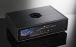 HiFi Rose RS130 Uncompromised Audio Purity With a focus on delivering pristine sound, the RS130 is engineered to eliminate digital noise and ensure stable output. Its support for Fiber Optic Ethernet and Fiber Optic USB effectively blocks unwanted noise sources, allowing you to indulge in pure audio bliss. The built-in high-precision OCXO clock guarantees precise timing, maintaining a constant temperature for stable and accurate clock signals. Sophisticated Aesthetics and Engineered for Perfection Designed to captivate audiophiles both audibly and visually, the RS130 boasts exquisite crystal buttons that exude class and elegance. Complemented by a novel symbol logo-inspired ventilation hole, the RS130 ensures efficient heat dissipation while adding a touch of sophistication to your space. Pure Power, Pure Sound For the cleanest and most stable power supply, the RS130 employs a linear power stage powered by a high-capacity supercapacitor. This innovative approach reduces power supply noise to near battery levels, resulting in cleaner and more natural sound quality. Unleashing Precision Experience unrivaled precision with the high-precision OCXO. This cutting-edge clock source delivers an accurate and stable clock signal unaffected by temperature changes. Say goodbye to jitter in the audio signal, and embrace a more stable and precise audio performance. Unrivaled Noise Suppression The RS130 leverages Fiber Optic Ethernet to completely isolate network digital noise. It effectively blocks physical noise sources, including various network equipment. Similarly, the Fiber Optic USB employs optical conversion to separate pure data from driving noise, ensuring only flawless sound reaches your DAC. Seamless Synchronization Embrace perfect synchronization with the RS130's external master clock input. This intelligent feature ensures that audio data is output in sync with the master clock, eliminating jitter in connections between the audio source and the DAC for a harmonious performance. Music, Cached for Perfection With an applied SSD for music caching, the RS130 ensures stable playback by eliminating the effects of vibration and noise from traditional HDDs. Delight in seamless network streaming with minimized delay errors.