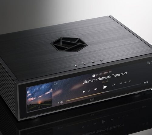 HiFi Rose RS130 Uncompromised Audio Purity With a focus on delivering pristine sound, the RS130 is engineered to eliminate digital noise and ensure stable output. Its support for Fiber Optic Ethernet and Fiber Optic USB effectively blocks unwanted noise sources, allowing you to indulge in pure audio bliss. The built-in high-precision OCXO clock guarantees precise timing, maintaining a constant temperature for stable and accurate clock signals. Sophisticated Aesthetics and Engineered for Perfection Designed to captivate audiophiles both audibly and visually, the RS130 boasts exquisite crystal buttons that exude class and elegance. Complemented by a novel symbol logo-inspired ventilation hole, the RS130 ensures efficient heat dissipation while adding a touch of sophistication to your space. Pure Power, Pure Sound For the cleanest and most stable power supply, the RS130 employs a linear power stage powered by a high-capacity supercapacitor. This innovative approach reduces power supply noise to near battery levels, resulting in cleaner and more natural sound quality. Unleashing Precision Experience unrivaled precision with the high-precision OCXO. This cutting-edge clock source delivers an accurate and stable clock signal unaffected by temperature changes. Say goodbye to jitter in the audio signal, and embrace a more stable and precise audio performance. Unrivaled Noise Suppression The RS130 leverages Fiber Optic Ethernet to completely isolate network digital noise. It effectively blocks physical noise sources, including various network equipment. Similarly, the Fiber Optic USB employs optical conversion to separate pure data from driving noise, ensuring only flawless sound reaches your DAC. Seamless Synchronization Embrace perfect synchronization with the RS130's external master clock input. This intelligent feature ensures that audio data is output in sync with the master clock, eliminating jitter in connections between the audio source and the DAC for a harmonious performance. Music, Cached for Perfection With an applied SSD for music caching, the RS130 ensures stable playback by eliminating the effects of vibration and noise from traditional HDDs. Delight in seamless network streaming with minimized delay errors.